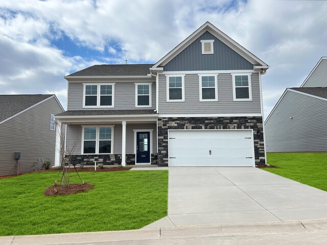 view of front facade with a garage and a front lawn