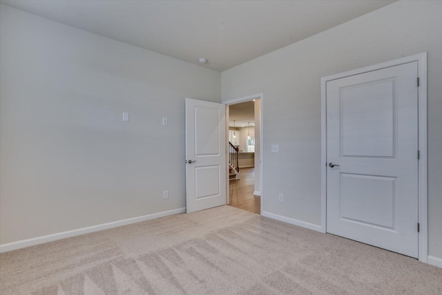 unfurnished bedroom featuring light carpet