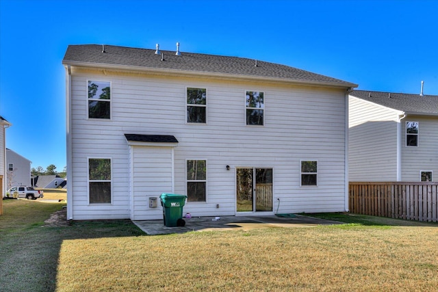 back of house with a yard and a patio