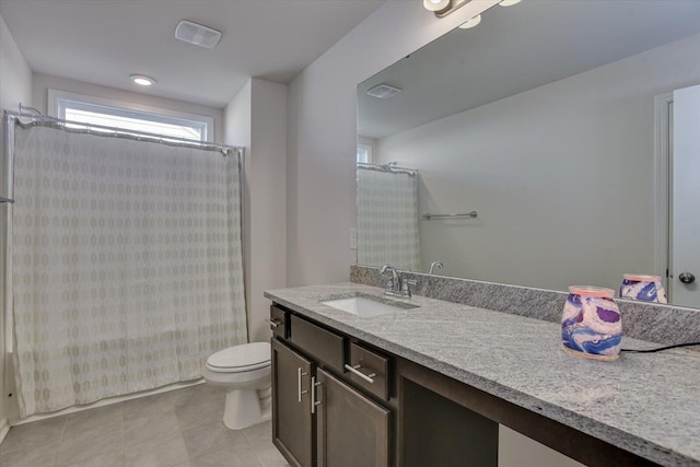 bathroom with tile patterned flooring, vanity, and toilet