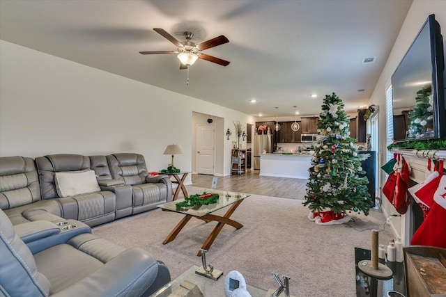 living room featuring hardwood / wood-style flooring and ceiling fan