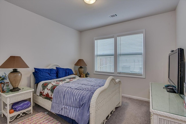 bedroom with dark colored carpet