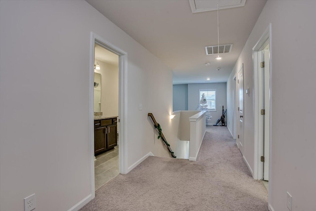 hallway featuring light colored carpet