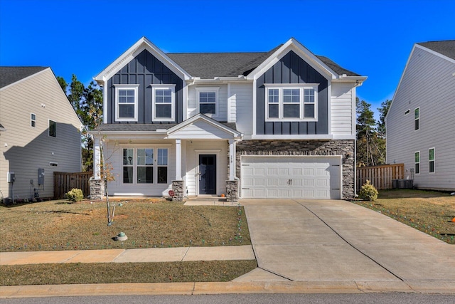 craftsman-style home featuring a front lawn, central AC unit, and a garage