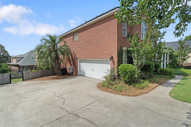 3637 Foxfire Pl, Martinez, GA 30907 - view of side of home with concrete driveway, a garage, and brick siding