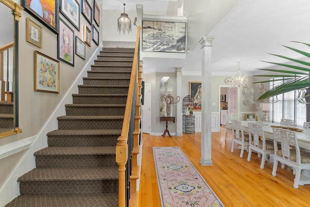 3637 Foxfire Pl, Martinez, GA 30907 - stairway with decorative columns, wood finished floors, crown molding, and a chandelier