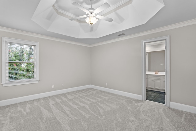 3997 Hammonds Fry, Evans, GA 30809 - unfurnished bedroom featuring a tray ceiling, carpet flooring, crown molding, connected bathroom, and ceiling fan