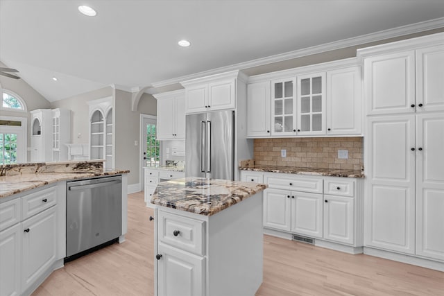 3997 Hammonds Fry, Evans, GA 30809 - kitchen with appliances with stainless steel finishes, light wood-style flooring, decorative backsplash, healthy amount of natural light, and vaulted ceiling