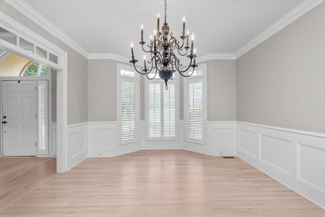 3997 Hammonds Fry, Evans, GA 30809 - unfurnished dining area with a chandelier, crown molding, light wood-type flooring, a wainscoted wall, and a decorative wall
