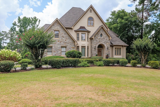 3997 Hammonds Fry, Evans, GA 30809 - french country inspired facade with stucco siding, stone siding, a front lawn, and a standing seam roof