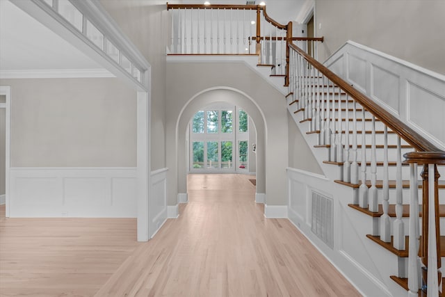 3997 Hammonds Fry, Evans, GA 30809 - foyer featuring arched walkways, wood finished floors, stairway, a decorative wall, and a towering ceiling