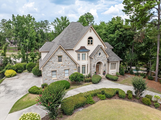 3997 Hammonds Fry, Evans, GA 30809 - french country style house featuring stucco siding, stone siding, concrete driveway, and a standing seam roof
