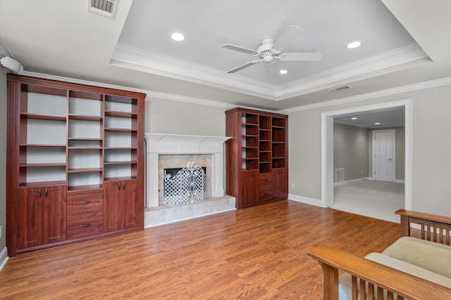 3997 Hammonds Fry, Evans, GA 30809 - unfurnished living room with light wood-style flooring, ceiling fan, a raised ceiling, recessed lighting, and a premium fireplace