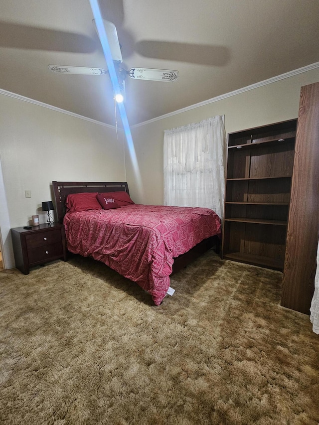 bedroom featuring ceiling fan, ornamental molding, and dark carpet