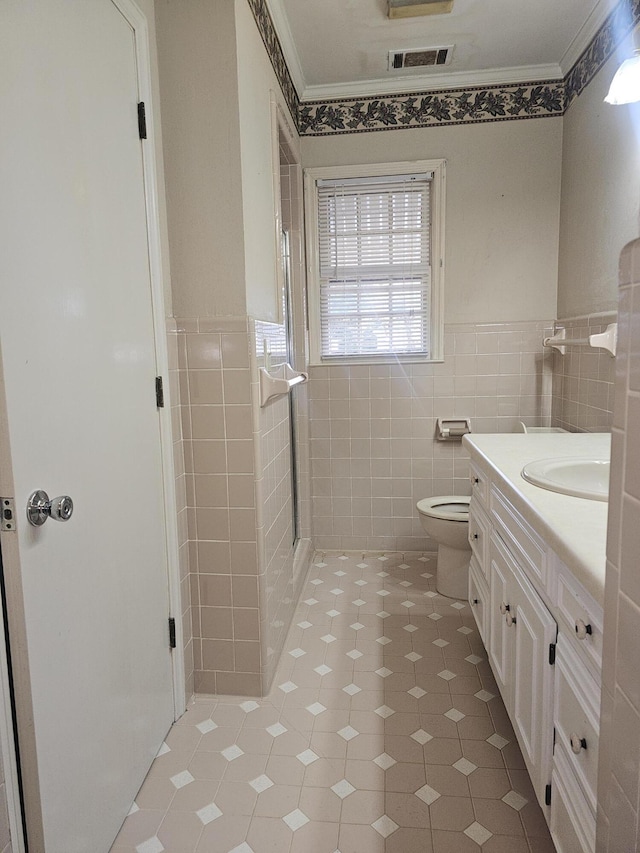 full bathroom with tile patterned floors, vanity, tile walls, and crown molding