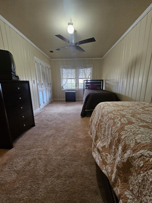 carpeted bedroom with ornamental molding, visible vents, and a ceiling fan