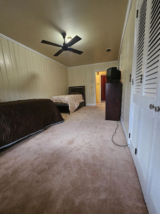 unfurnished bedroom with light carpet, ceiling fan, visible vents, and crown molding