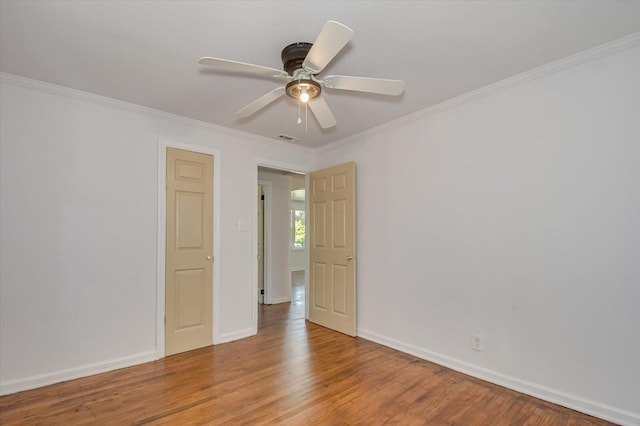 spare room with hardwood / wood-style flooring, ceiling fan, and ornamental molding