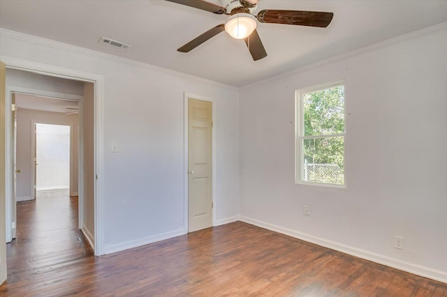 unfurnished bedroom with ornamental molding, ceiling fan, and dark wood-type flooring