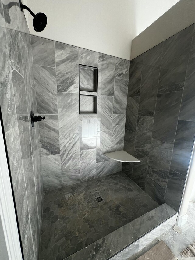 bathroom with a tile shower