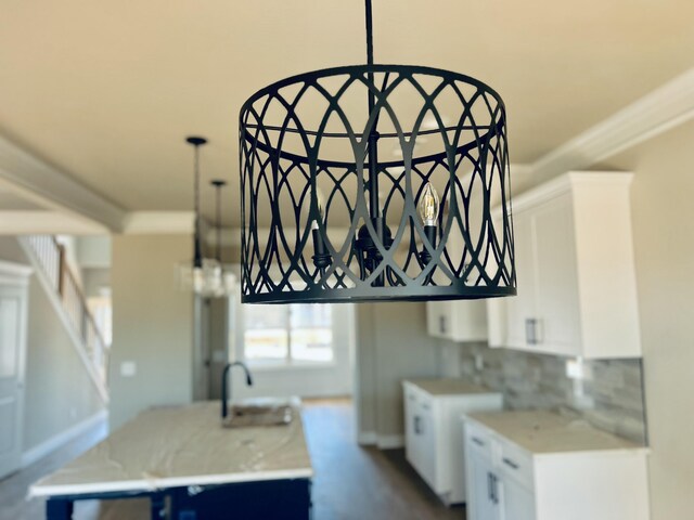 kitchen with white cabinets, light countertops, and a sink