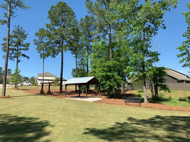 surrounding community with a lawn and a gazebo