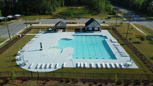 view of swimming pool featuring a gazebo, a yard, and fence