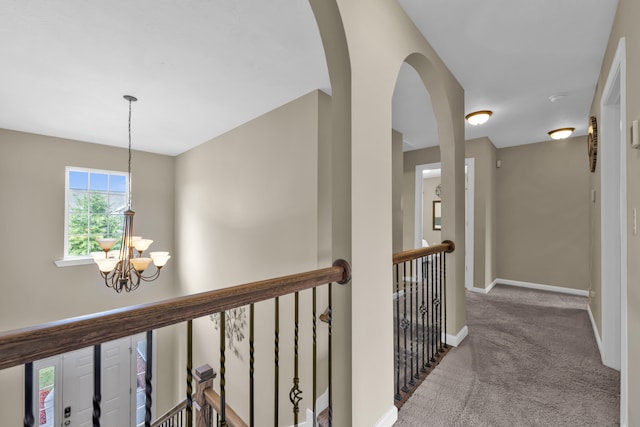 532 Bunchgrass St, Evans, GA 30809 - hallway featuring a chandelier, carpet flooring, baseboards, arched walkways, and an upstairs landing