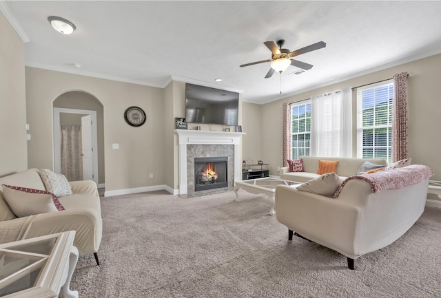 532 Bunchgrass St, Evans, GA 30809 - carpeted living area with ornamental molding, a ceiling fan, arched walkways, baseboards, and a tiled fireplace