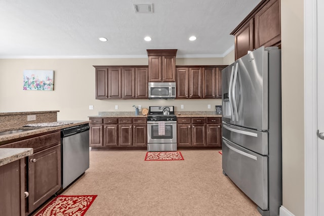 532 Bunchgrass St, Evans, GA 30809 - kitchen featuring stainless steel appliances, dark brown cabinets, ornamental molding, light stone counters, and recessed lighting