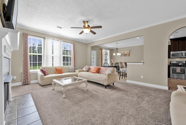 532 Bunchgrass St, Evans, GA 30809 - living area with crown molding, a ceiling fan, light carpet, baseboards, and arched walkways