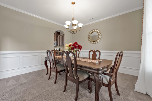 532 Bunchgrass St, Evans, GA 30809 - dining room featuring crown molding, light colored carpet, arched walkways, a chandelier, and wainscoting