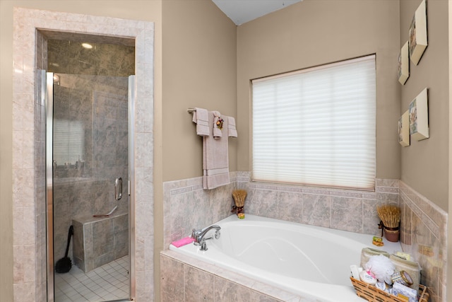 full bathroom featuring a garden tub and a stall shower