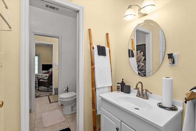 bathroom with visible vents, toilet, tile patterned flooring, and vanity