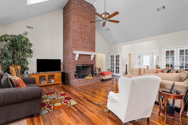 living area with visible vents, high vaulted ceiling, a ceiling fan, and french doors