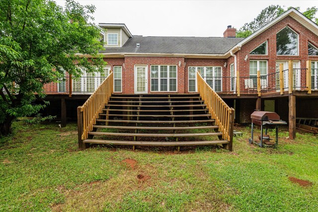 back of house with a deck, stairs, and brick siding