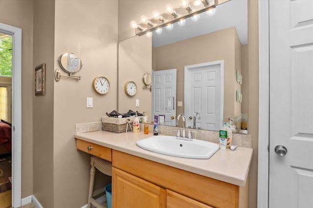 ensuite bathroom with vanity and connected bathroom