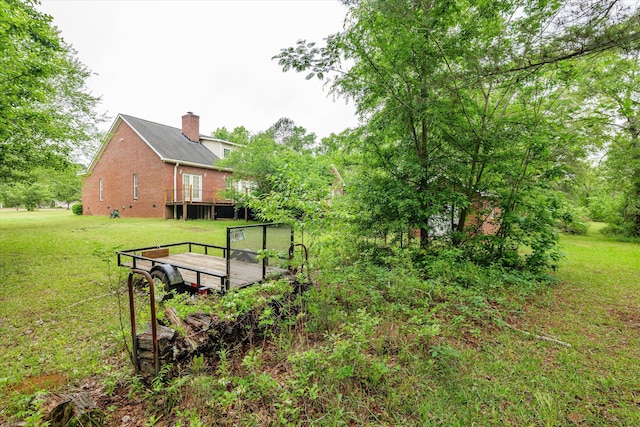 exterior space with a deck and a yard