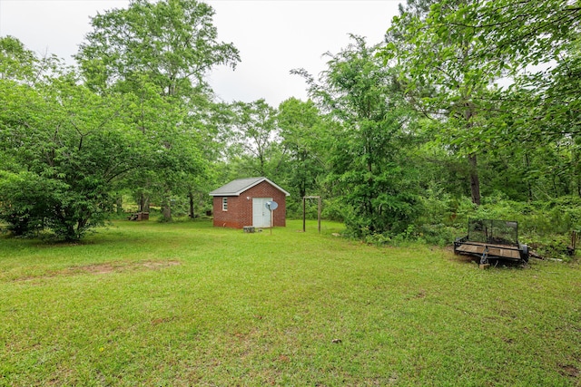 view of yard featuring an outbuilding and a storage unit