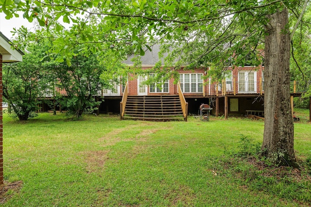 view of yard with a deck and stairs