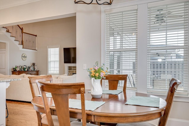 dining space with a fireplace and light wood-style flooring