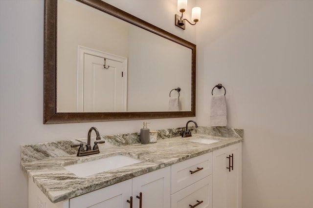 bathroom featuring a sink and double vanity