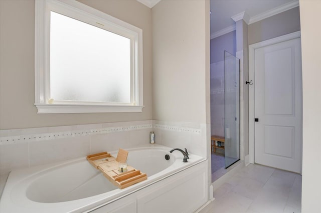 bathroom featuring a garden tub, tile patterned flooring, and ornamental molding