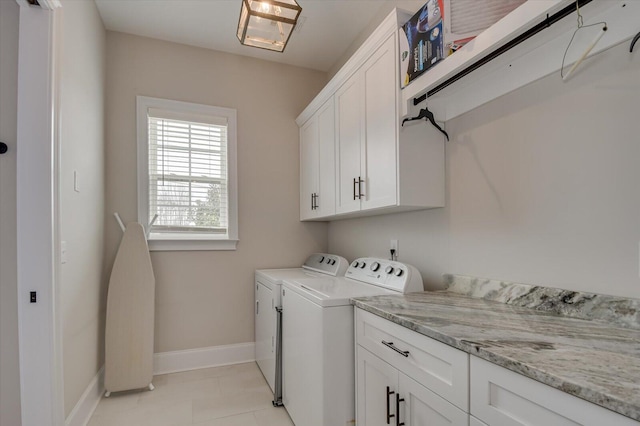 laundry area featuring cabinet space, light tile patterned flooring, baseboards, and independent washer and dryer