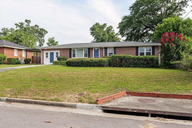 2211 Woodland Ave, Augusta, GA 30904 - ranch-style house with brick siding, a front yard, a carport, and driveway