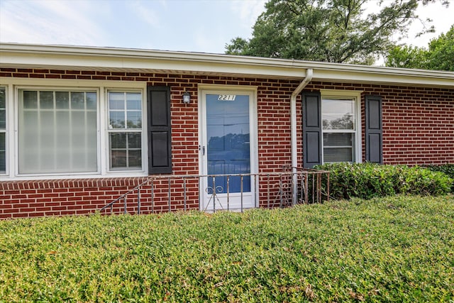 2211 Woodland Ave, Augusta, GA 30904 - view of exterior entry with brick siding and a yard