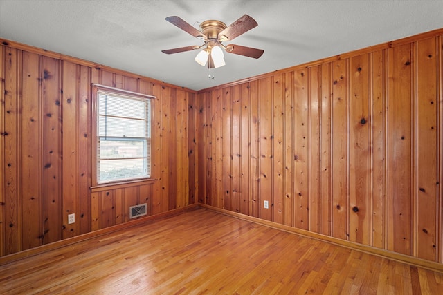 2211 Woodland Ave, Augusta, GA 30904 - unfurnished room with wood finished floors, wooden walls, and ceiling fan