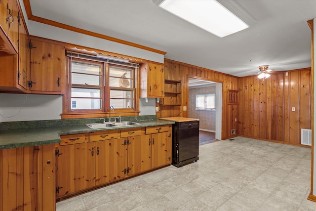 2211 Woodland Ave, Augusta, GA 30904 - kitchen featuring light flooring, dishwasher, dark countertops, wood walls, and brown cabinets
