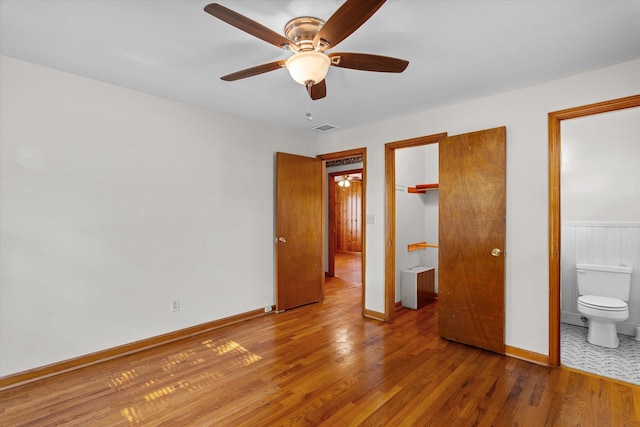 2211 Woodland Ave, Augusta, GA 30904 - unfurnished bedroom with wood finished floors, ensuite bathroom, and ceiling fan