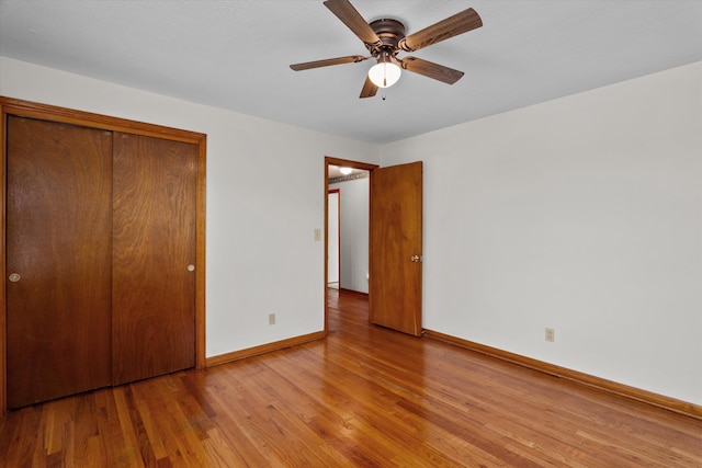 2211 Woodland Ave, Augusta, GA 30904 - unfurnished bedroom with light wood-style flooring, a closet, and a ceiling fan